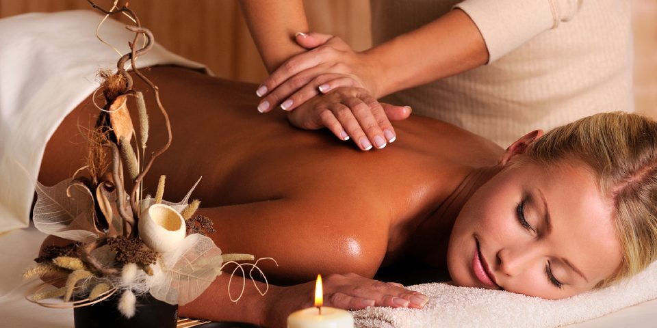 Woman Experiencing A Massage Therapy In A Well Known Massage Centre By A Professional Massage Therapist.